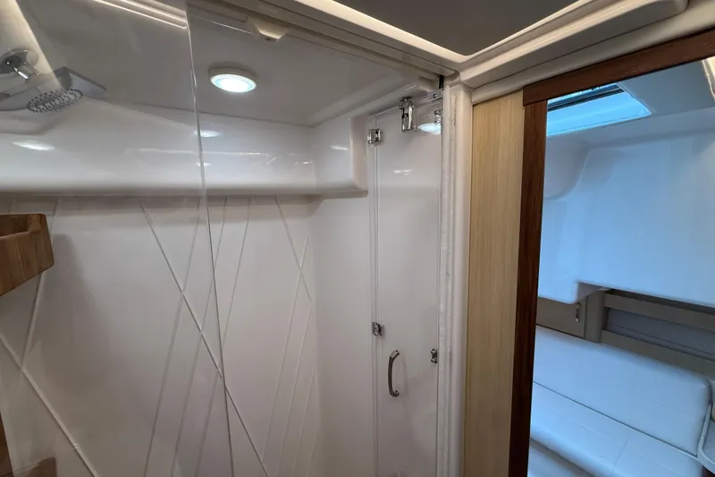 Slide: The Image of 2026 Regal 36 Grande Coupe interior shower with modern design and wooden accents. - 85