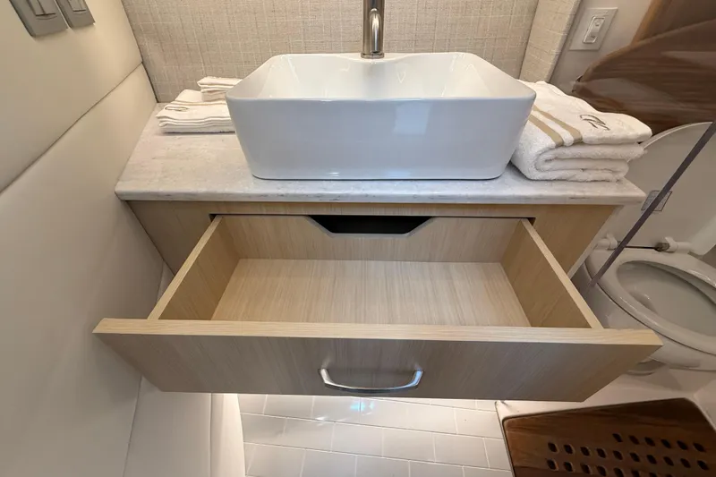 Slide: The Image of Modern bathroom vanity with open drawer in 2026 Regal 36 Grande Coupe yacht. - 90