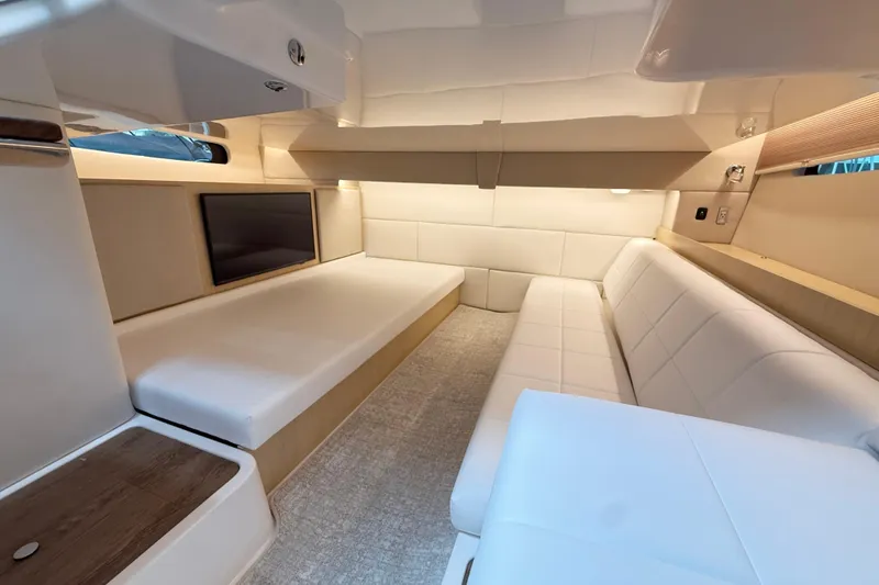 Slide: The Image of Luxurious interior of 2026 Regal 36 Grande Coupe yacht with modern seating and ambient lighting. - 93