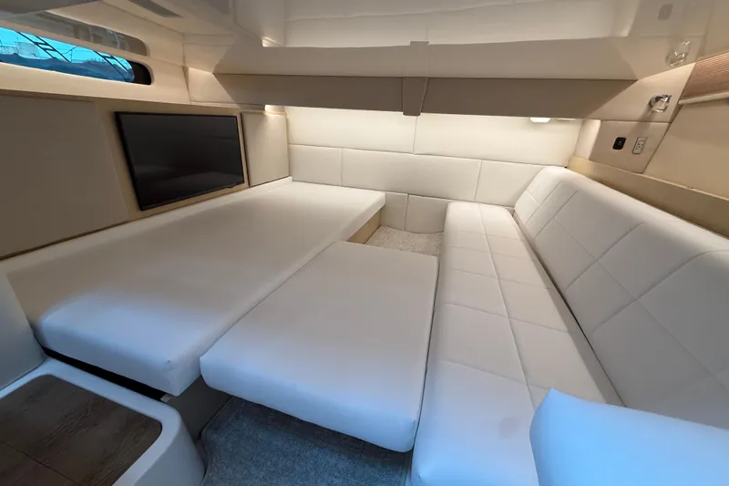 Slide: The Image of Luxurious interior of 2026 Regal 36 Grande Coupe with white seating and TV. - 94