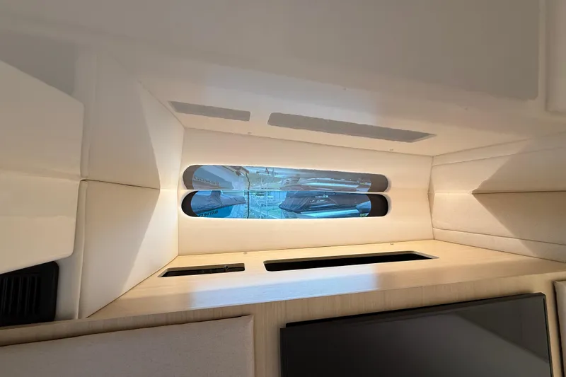Slide: The Image of Interior view of 2026 Regal 36 Grande Coupe yacht cabin with window. - 98