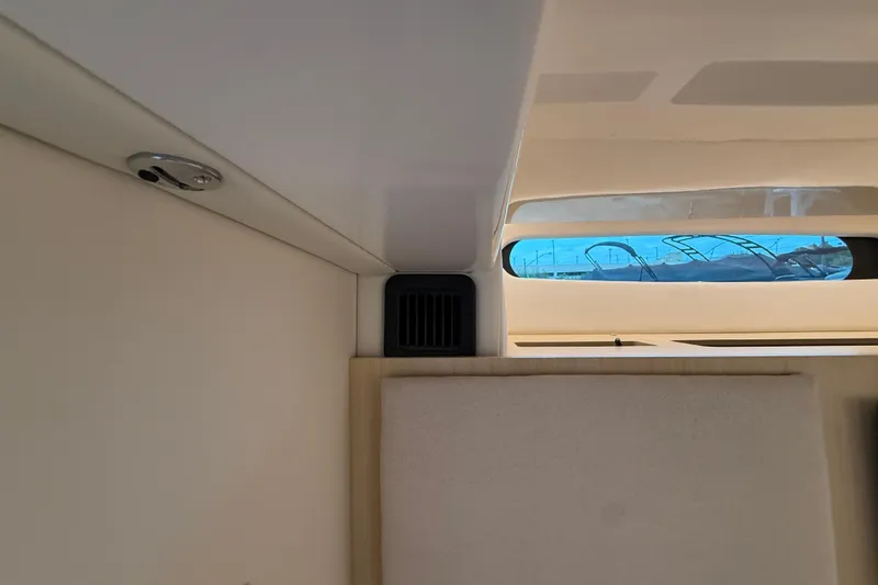 Slide: The Image of Interior view of 2026 Regal 36 Grande Coupe with window and vent detail. - 99