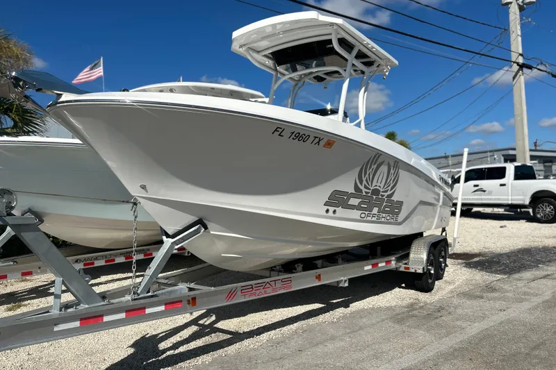 The Image of 2023 Wellcraft 222 Scarab Offshore boat on trailer, parked outdoors. - 1
