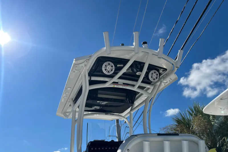 Slide: The Image of 2023 Wellcraft 222 Scarab Offshore boat with T-top under clear blue sky. - 12