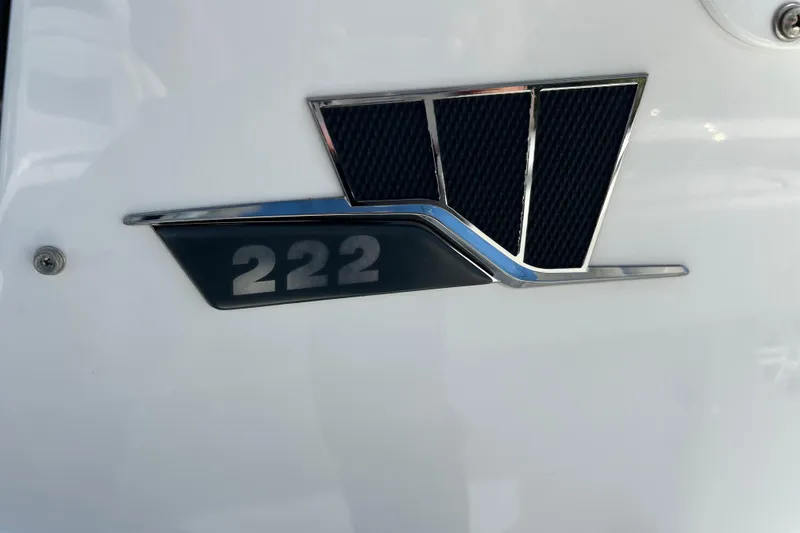 Slide: The Image of 2023 Wellcraft 222 Scarab Offshore emblem on white surface. - 14