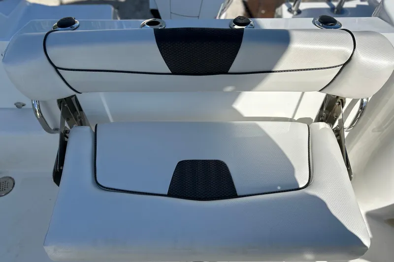 Slide: The Image of 2023 Wellcraft 222 Scarab Offshore boat seat with black and white upholstery. - 19