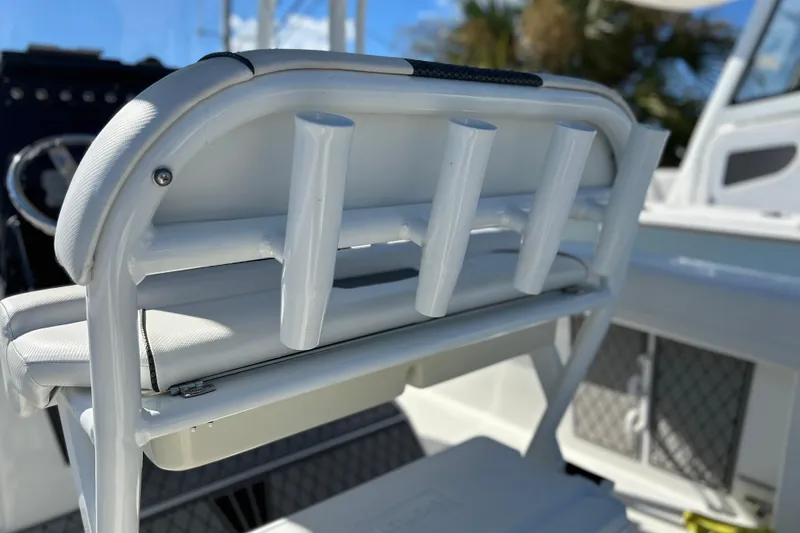 Slide: The Image of 2023 Wellcraft 222 Scarab Offshore boat seat with rod holders, showcasing sleek design. - 23