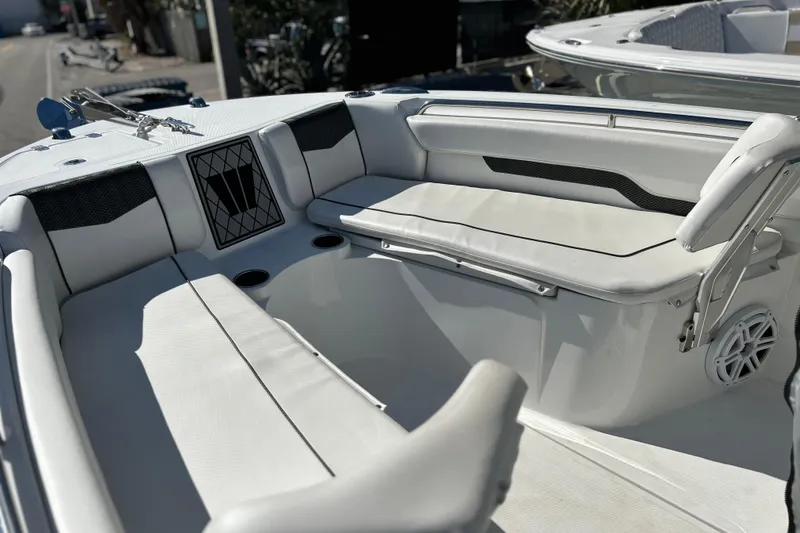 Slide: The Image of 2023 Wellcraft 222 Scarab Offshore boat interior with white seating and cup holders. - 28