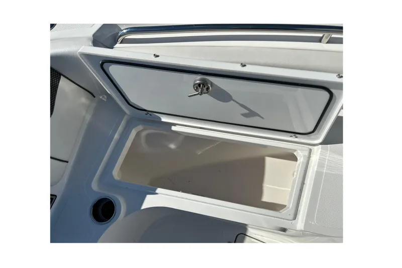 Slide: The Image of 2023 Wellcraft 222 Scarab Offshore storage compartment with open lid, showcasing interior space. - 33