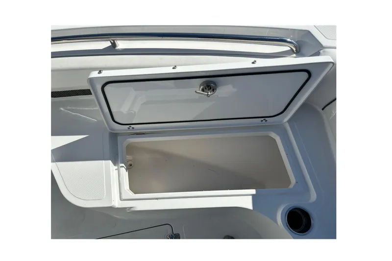 Slide: The Image of 2023 Wellcraft 222 Scarab Offshore storage compartment with open lid, showcasing interior space. - 34