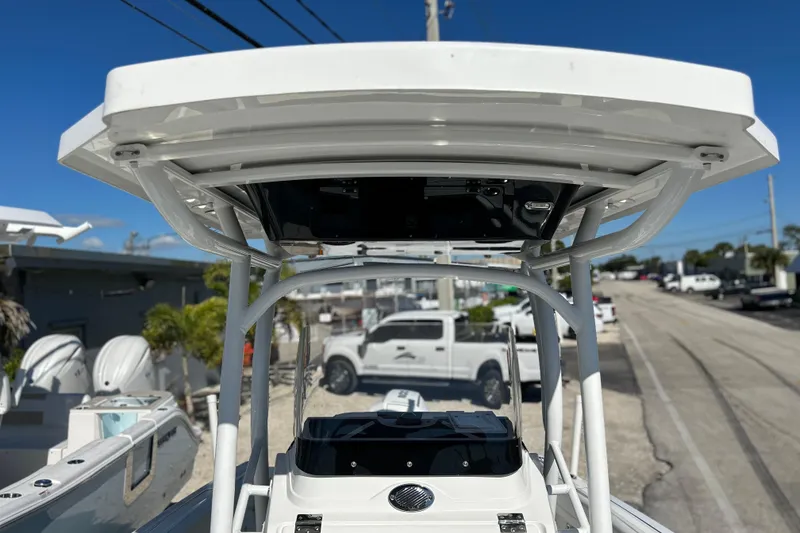 Slide: The Image of 2023 Wellcraft 222 Scarab Offshore boat with T-top, parked outdoors. - 38