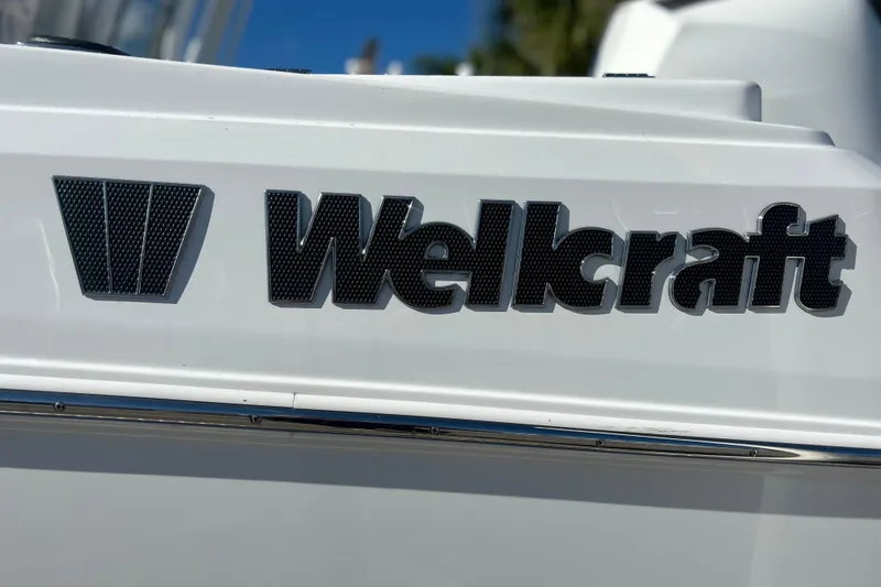 Slide: The Image of 2023 Wellcraft 222 Scarab Offshore boat logo on white surface. - 4