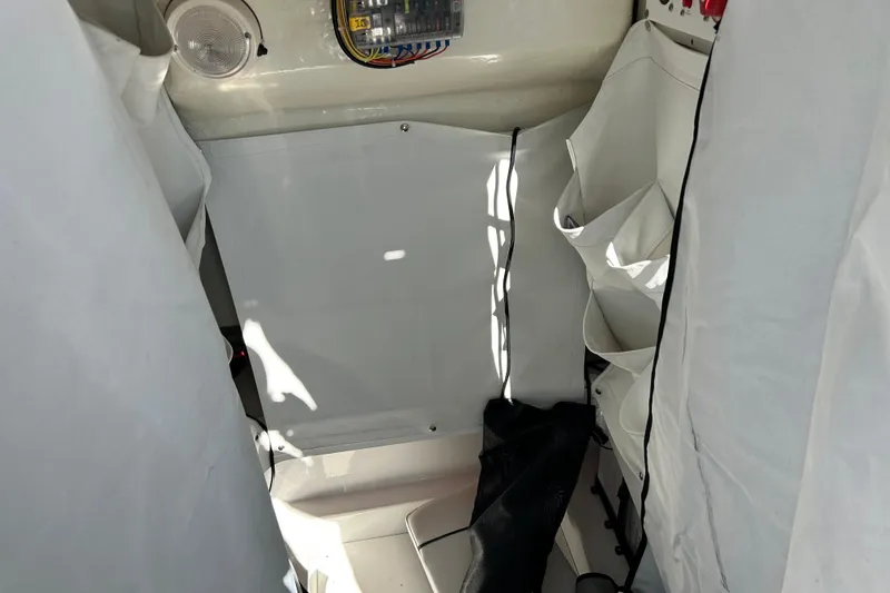 Slide: The Image of Interior of 2023 Wellcraft 222 Scarab Offshore boat, featuring storage compartments and electrical panel. - 40