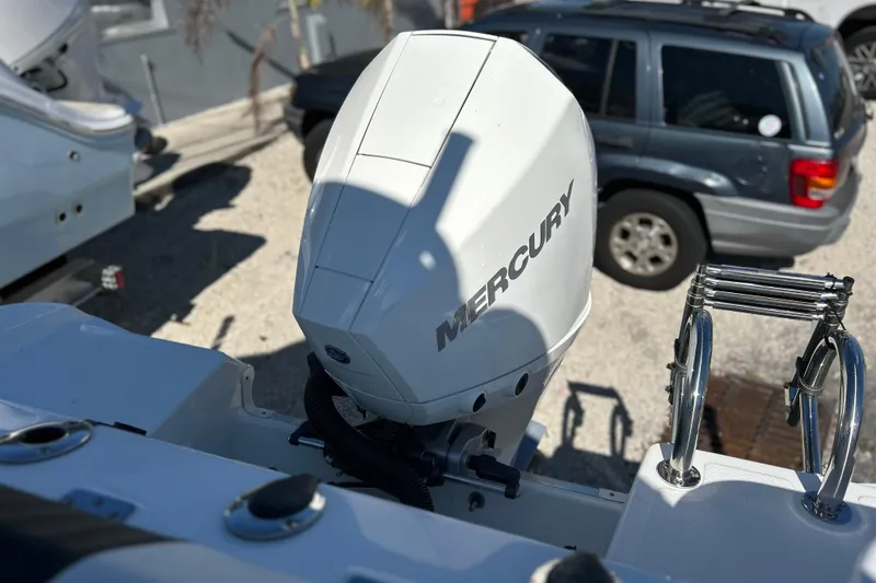 Slide: The Image of 2023 Wellcraft 222 Scarab Offshore with Mercury outboard engine, parked near a vehicle. - 42