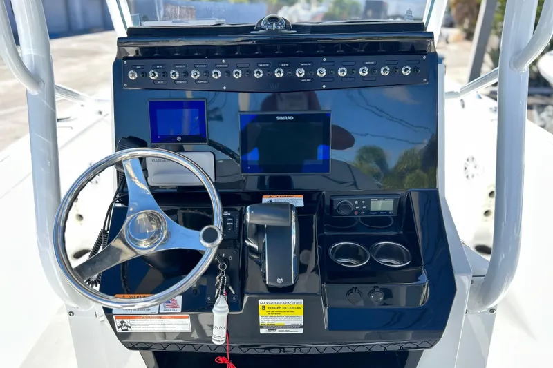 Slide: The Image of 2023 Wellcraft 222 Scarab Offshore boat dashboard with steering wheel and navigation controls. - 5
