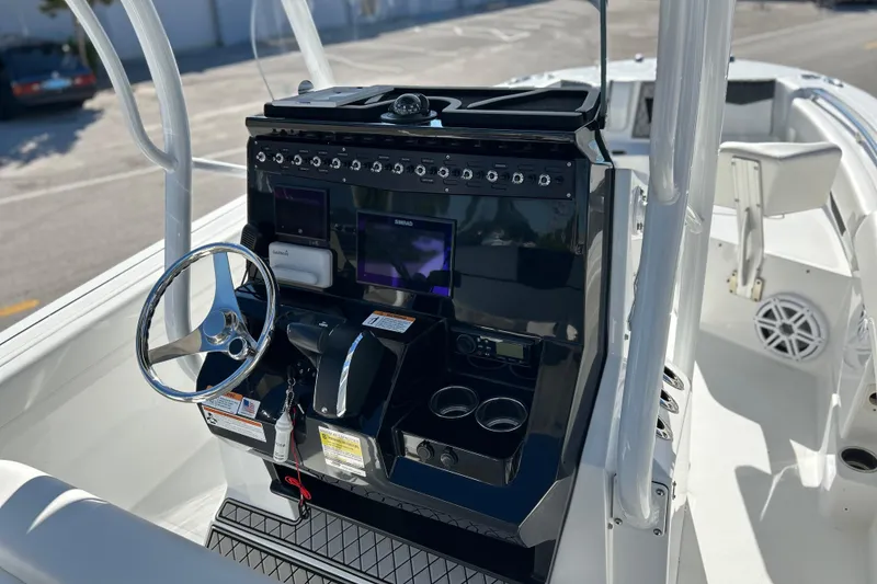 Slide: The Image of 2023 Wellcraft 222 Scarab Offshore boat console with steering wheel and navigation displays. - 9