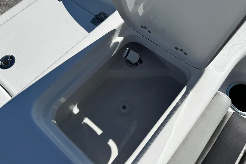 Slide: The Image of Open storage compartment on 2026 Sea Pro 242 Center Console boat. - 11