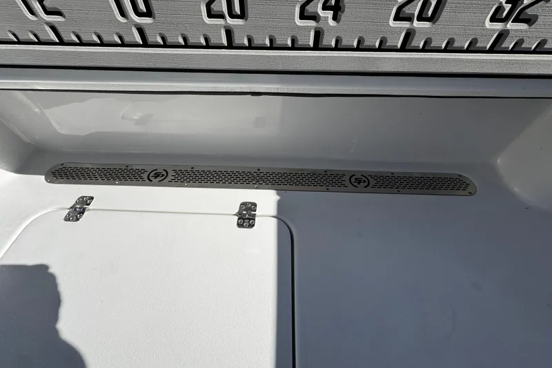 Slide: The Image of 2026 Sea Pro 242 Center Console boat interior with measurement markings and storage compartment. - 15
