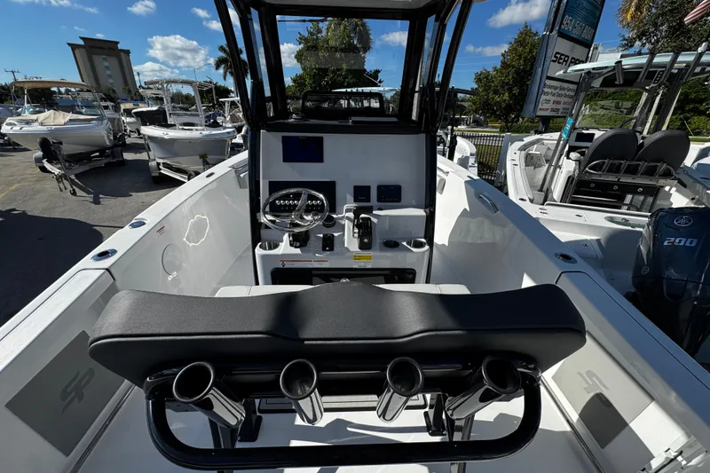 Slide: The Image of 2026 Sea Pro 242 Center Console boat interior with steering wheel and seating. - 19