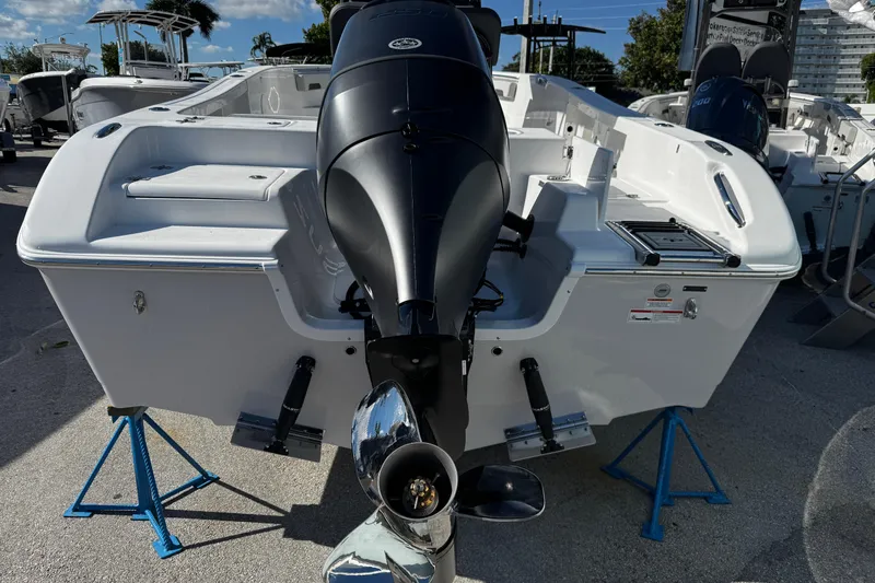 Slide: The Image of 2026 Sea Pro 242 Center Console boat on stands, rear view with outboard motor. - 3
