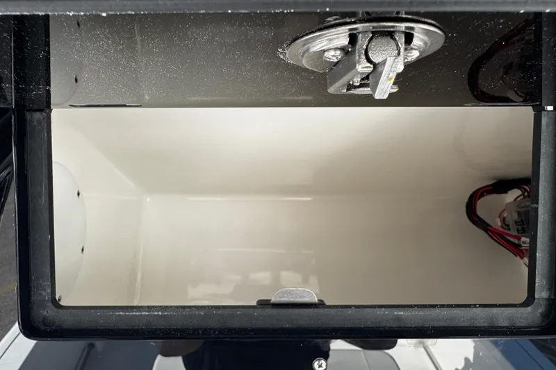 Slide: The Image of Storage compartment of 2026 Sea Pro 242 Center Console boat, featuring latch and wiring. - 33
