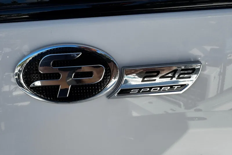 Slide: The Image of 2026 Sea Pro 242 Center Console emblem on a sleek white surface. - 34