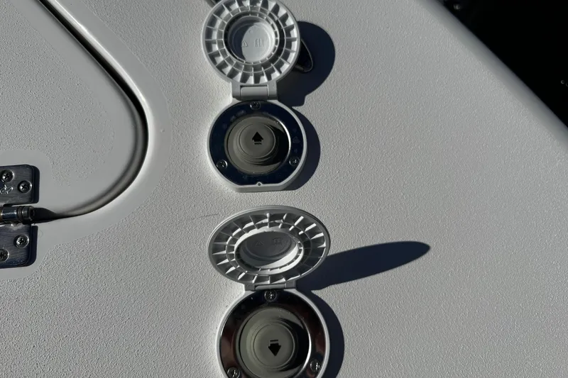 Slide: The Image of 2026 Sea Pro 242 Center Console boat deck with circular hatches and hinge detail. - 41