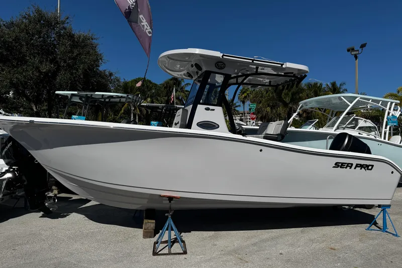 Slide: The Image of 2026 Sea Pro 242 Center Console boat displayed outdoors on stands. - 54