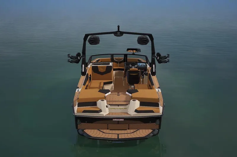 Slide: The Image of 2026 Nautique Super Air Nautique GS24 boat on calm water, rear view. - 6