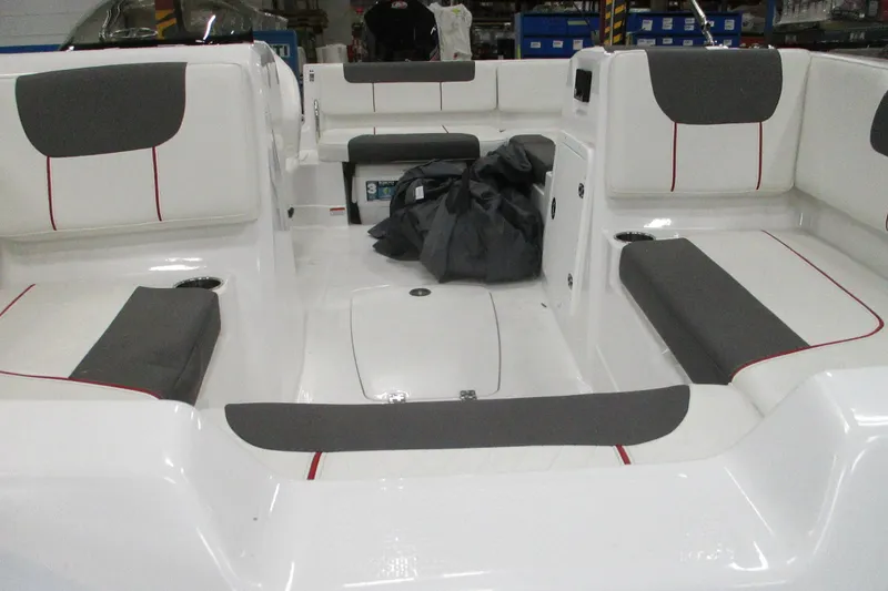 Slide: The Image of 2024 Tahoe 1950 boat interior with gray and white seating, cup holders, and storage compartments. - 4