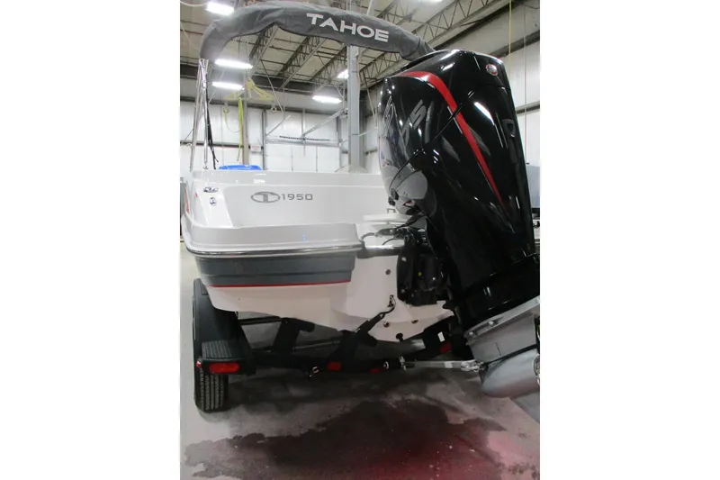 Slide: The Image of 2024 Tahoe 1950 boat with outboard motor in a warehouse setting. - 5