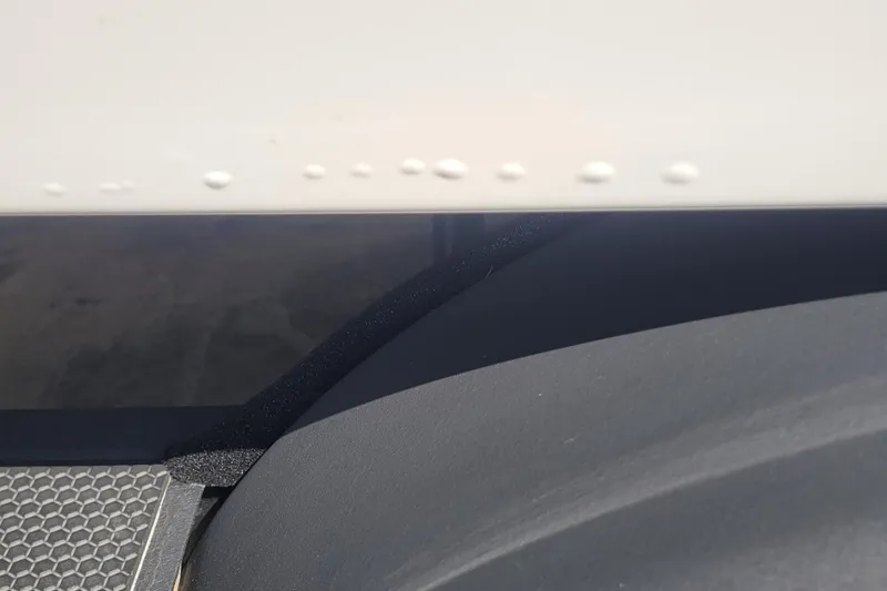 Slide: The Image of Close-up of 2024 Tahoe 1950 boat detailing with textured surface and rivets. - 9