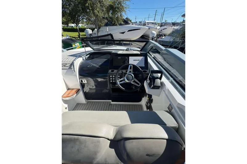 Slide: The Image of 2024 NX Boats NX290 cockpit with modern steering and control panel. - 6