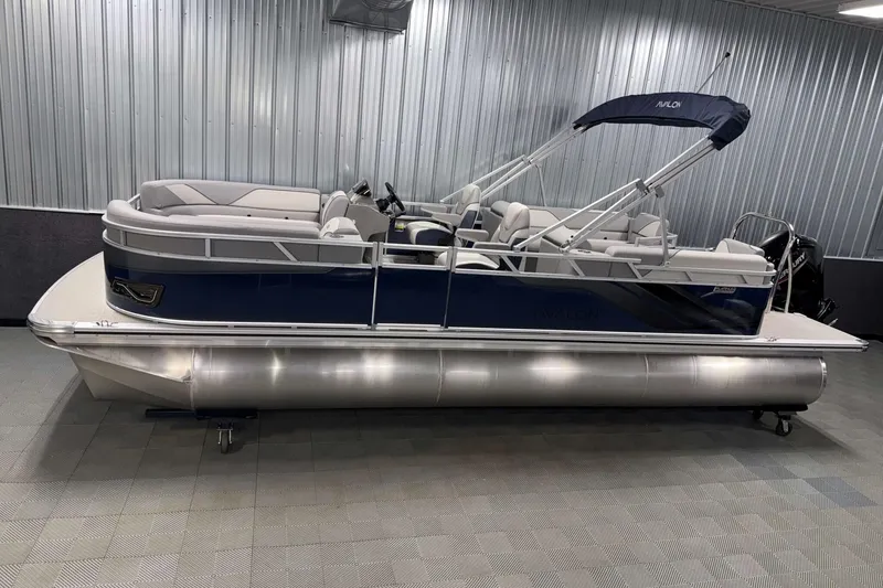 The Image of 2026 Avalon Venture 2385 QL pontoon boat in showroom, featuring sleek design and comfortable seating. - 1