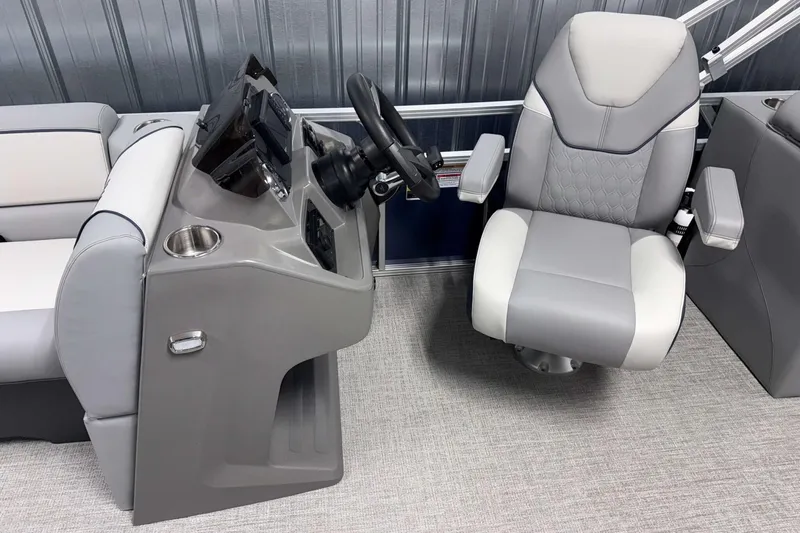 Slide: The Image of 2026 Avalon Venture 2385 QL boat interior with modern helm and comfortable captain's chair. - 15