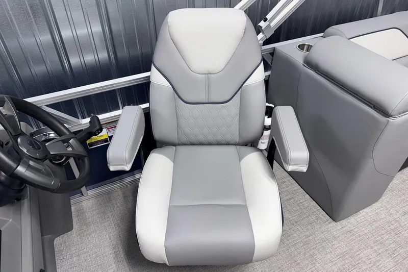 Slide: The Image of Captain's chair in 2026 Avalon Venture 2385 QL boat, featuring sleek gray upholstery. - 16