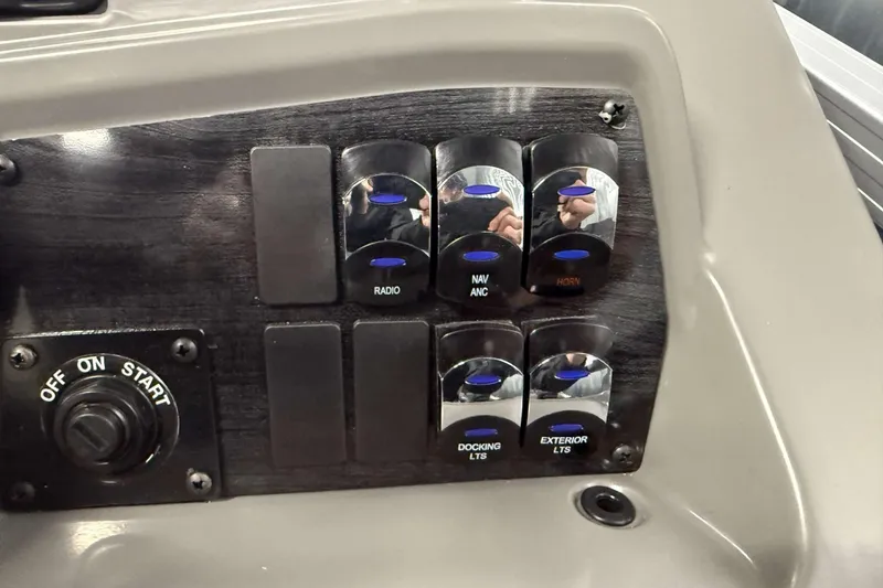 Slide: The Image of Control panel of 2026 Avalon Venture 2385 QL with labeled switches and ignition. - 23