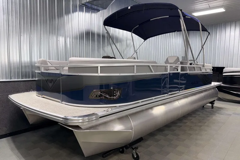 Slide: The Image of 2026 Avalon Venture 2385 QL pontoon boat with blue exterior and canopy in showroom. - 4