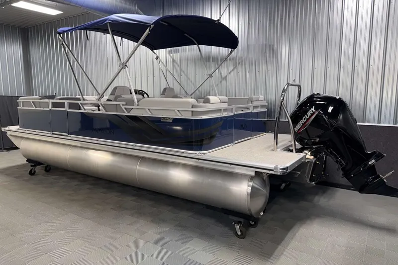 Slide: The Image of 2026 Avalon Venture 2385 QL pontoon boat with canopy and Mercury outboard motor in showroom. - 7