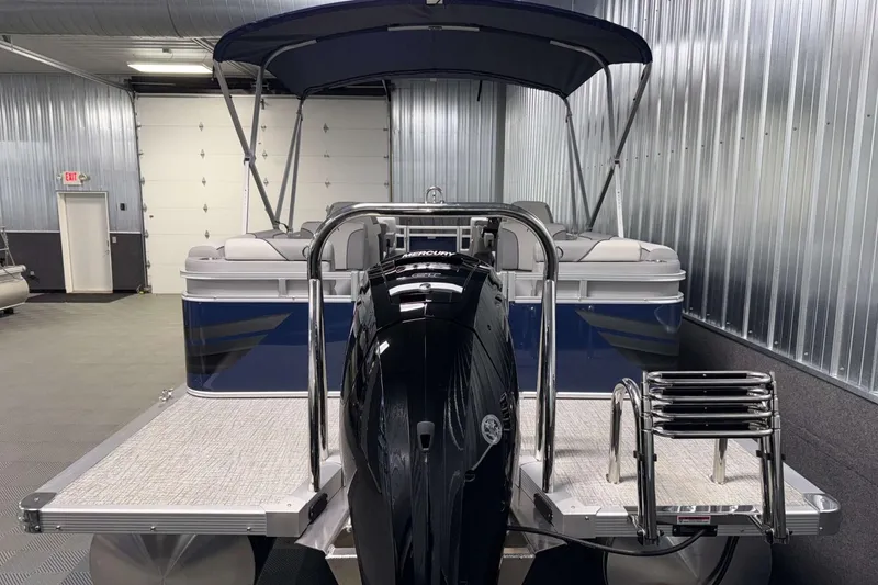 Slide: The Image of 2026 Avalon Venture 2385 QL pontoon boat in a showroom, featuring a sleek design. - 8