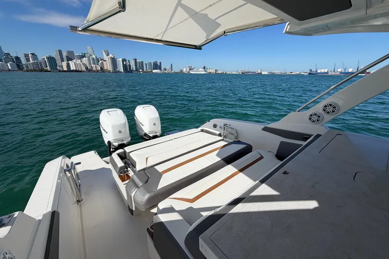 Slide: The Image of 2022 Tiara Yachts 34 LS on water with city skyline in background. - 10
