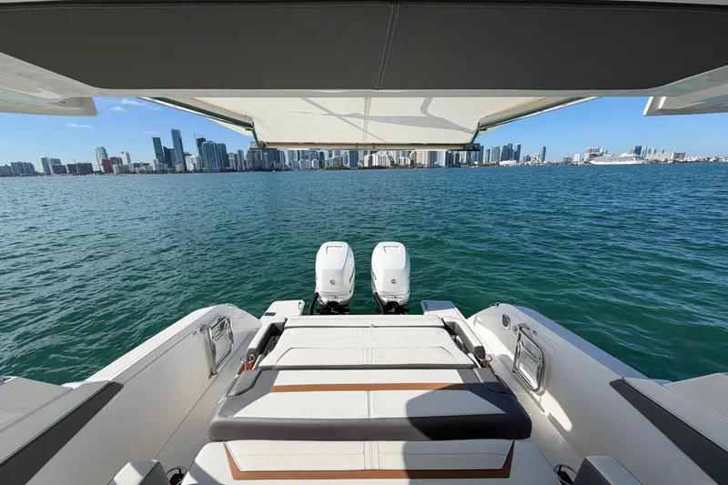 Slide: The Image of 2022 Tiara Yachts 34 LS on water with city skyline view. - 11