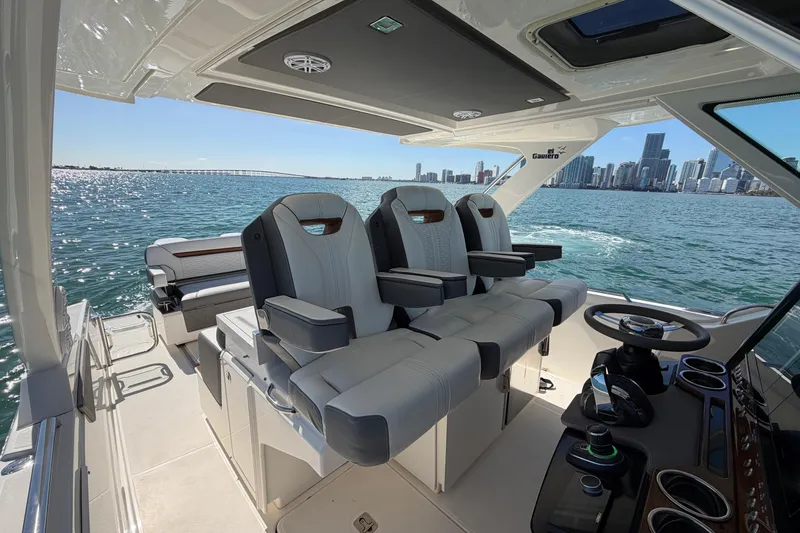Slide: The Image of 2022 Tiara Yachts 34 LS interior with luxurious seating and city skyline view. - 17