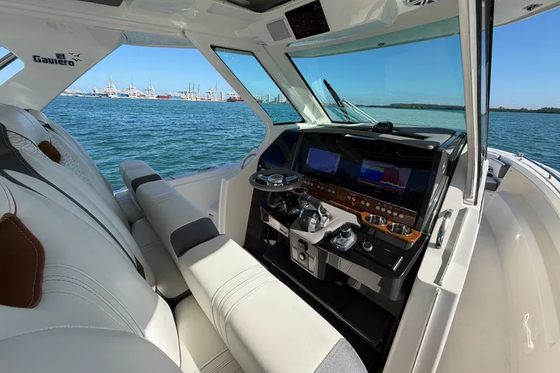 Slide: The Image of 2022 Tiara Yachts 34 LS helm with modern controls and ocean view. - 18