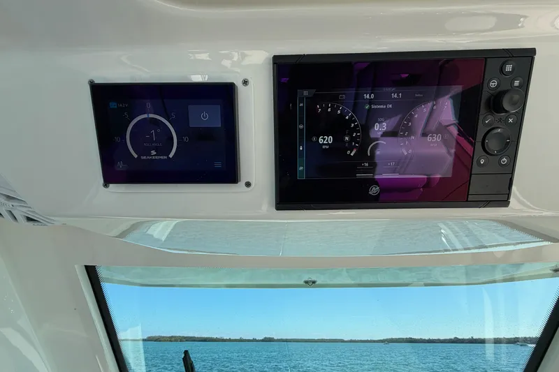 Slide: The Image of Dashboard of 2022 Tiara Yachts 34 LS with digital displays and sea view. - 20