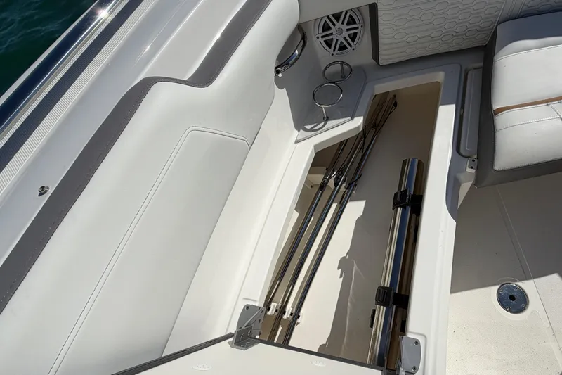 Slide: The Image of 2022 Tiara Yachts 34 LS interior storage compartment with fishing rod holders. - 24