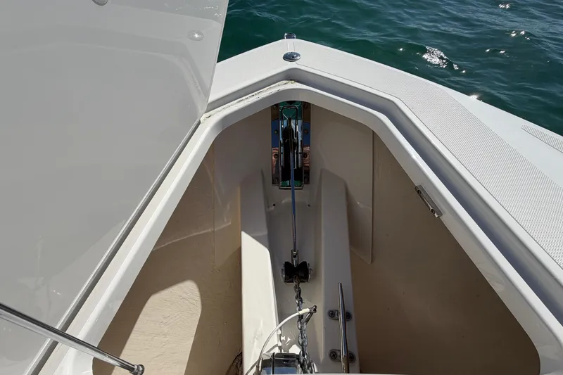 Slide: The Image of Anchor compartment of 2022 Tiara Yachts 34 LS, open hatch, ocean background. - 26