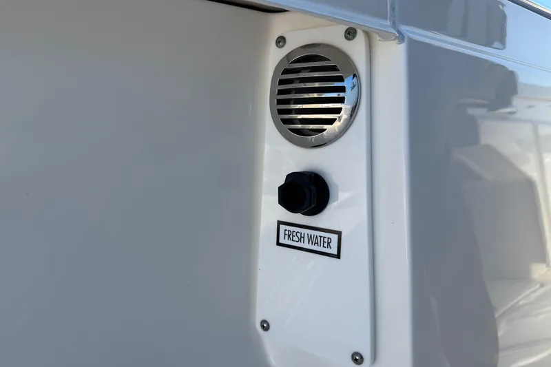 Slide: The Image of Tiara Yachts 34 LS 2022 fresh water outlet with vent on white surface. - 29