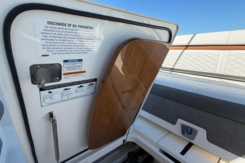 Slide: The Image of 2022 Tiara Yachts 34 LS interior with open hatch and safety warnings. - 30