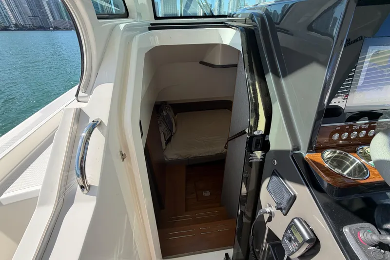 Slide: The Image of 2022 Tiara Yachts 34 LS cabin interior with helm and waterfront view. - 32